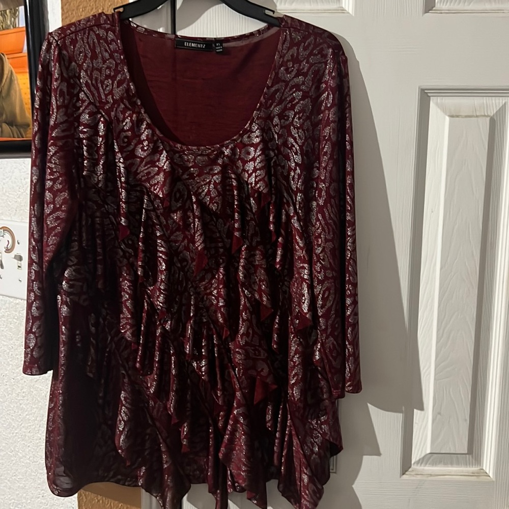 This burgundy top has silver animal print shimmer!